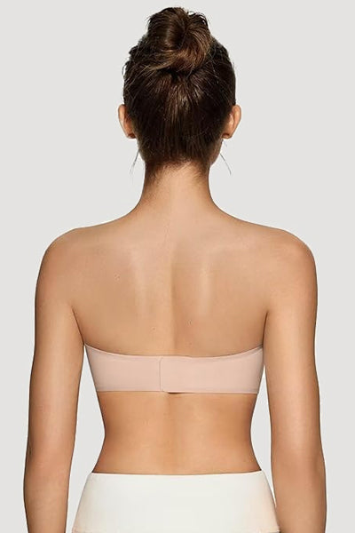A woman wearing a nude vertvie strapless bra.