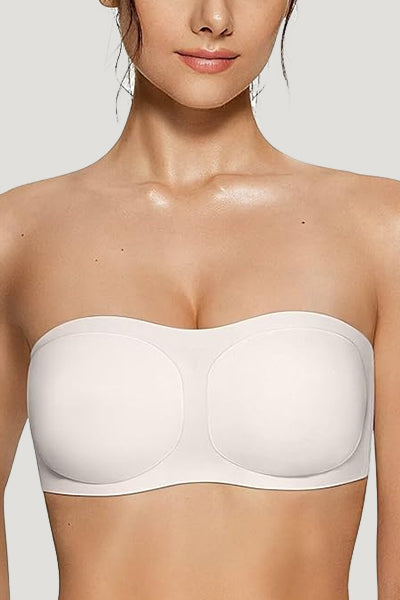 A woman wearing a white vertvie strapless bra.